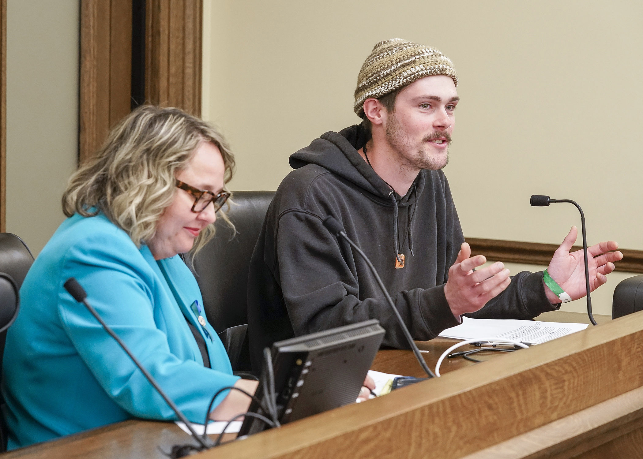 Mitch Ditlesen from Minneapolis testifies before the House Energy Finance and Policy Committee March 17 for a bill sponsored by Rep. Emma Greenman, left, that would limit rate recovery of executive pay for certain public utilities. (Photo by Andrew VonBank)
